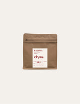 Brown coffee packaging with a white label on a beige background