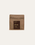 Brown coffee bag with 'Elyna' branding on a beige background