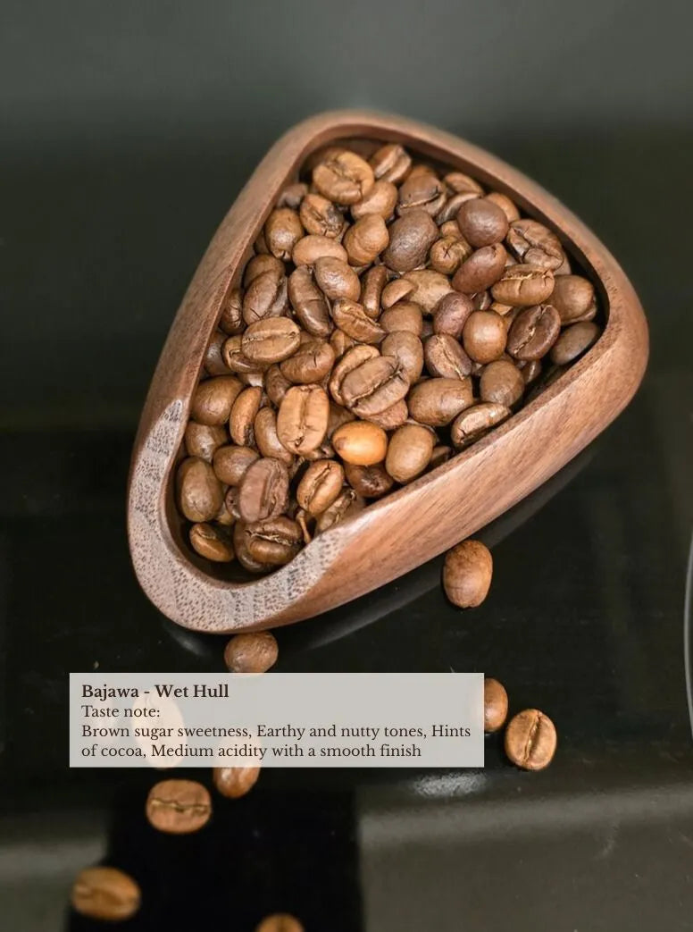 bajawa wet hulled coffee beans in wooden scoop — brown sugar sweetness, earthy and nutty tones, hints of cocoa