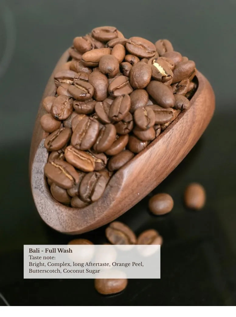 bali belantih full wash coffee beans in wooden scoop — bright complex, long aftertaste, orange peel, butterscotch and coconut sugar