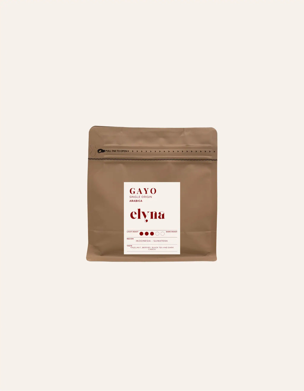 Brown coffee packaging with a white label on a beige background