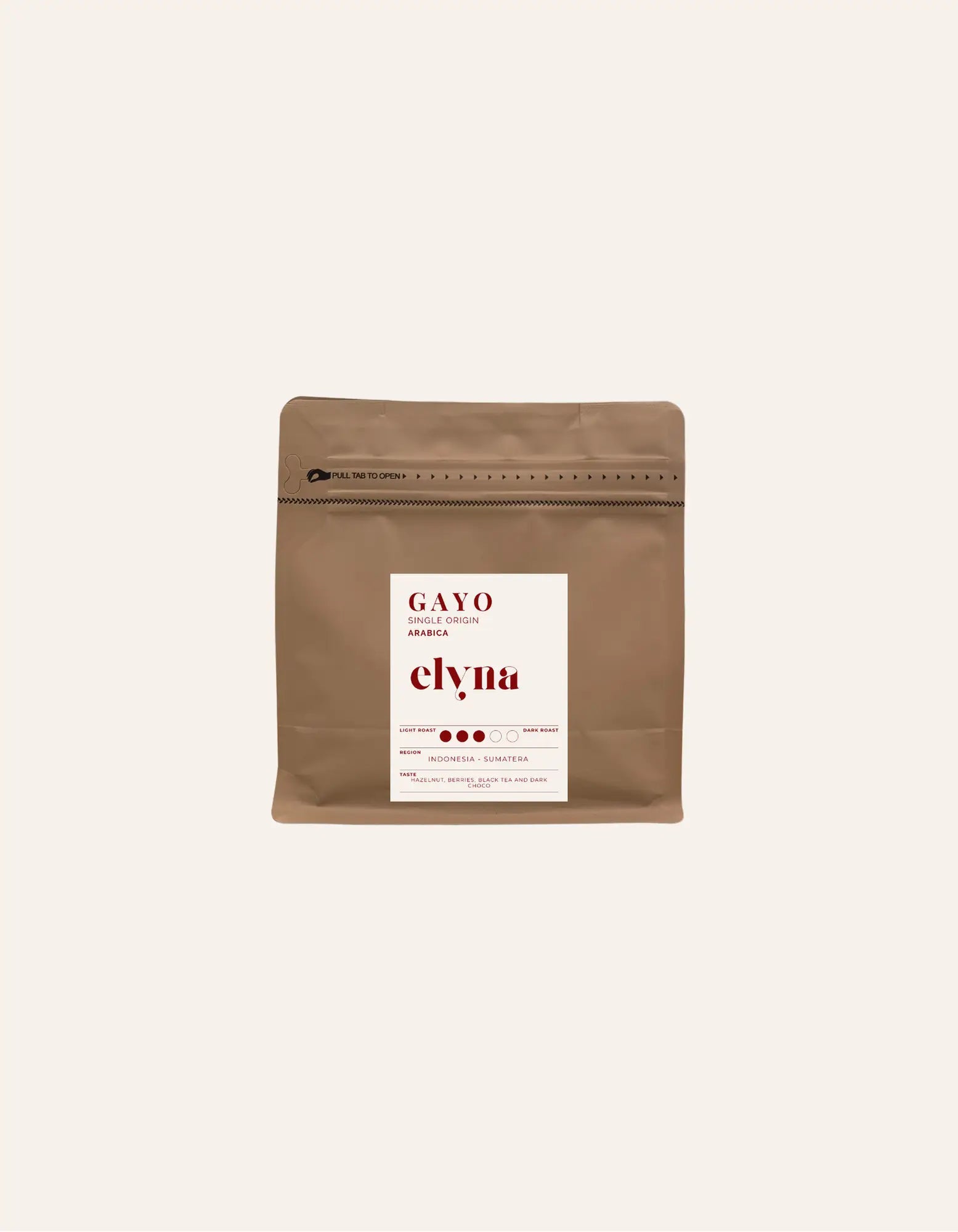Brown coffee packaging with a white label on a beige background