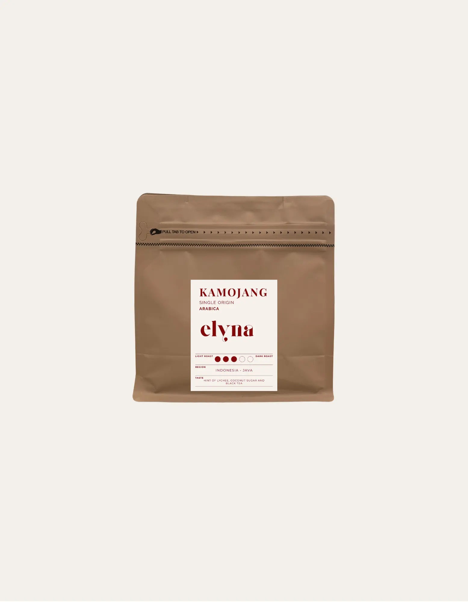 Brown coffee packaging with a white label on a beige background