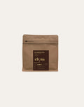 Brown coffee packaging with 'elvia' branding on a beige background