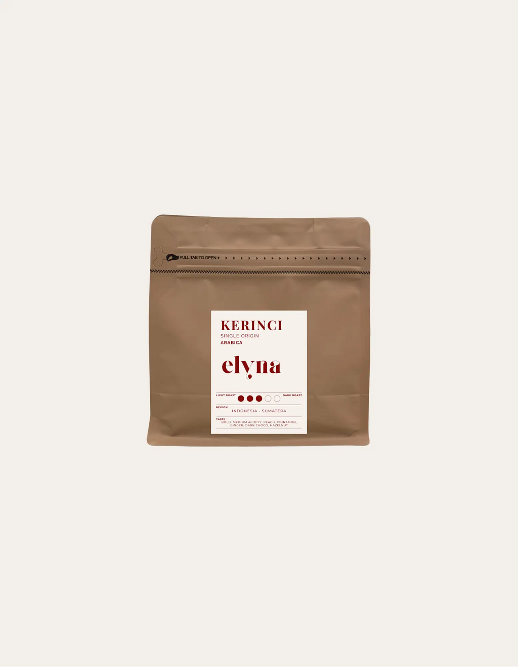 Brown coffee packaging with a white label on a beige background