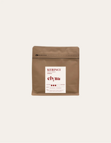 Brown coffee packaging with a white label on a beige background