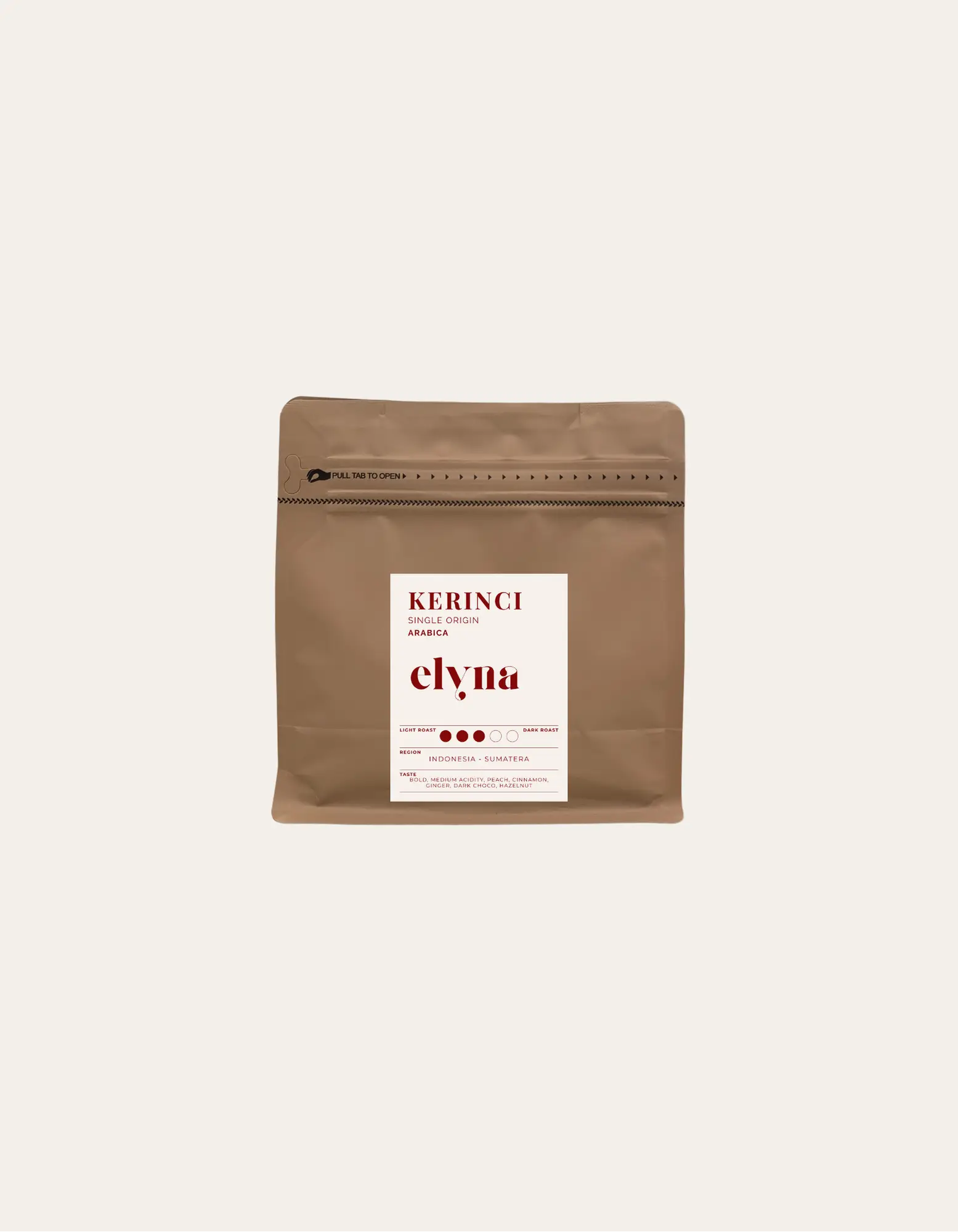 Brown coffee packaging with a white label on a beige background