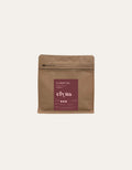 Brown coffee packaging with a red label on a beige background