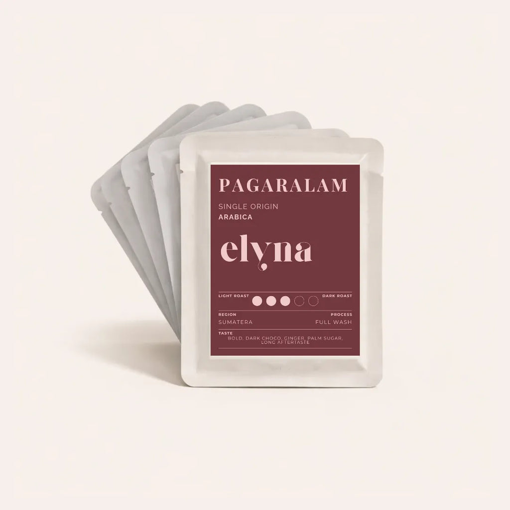 Pack of elyna coffee drip bags with a maroon label on a light pink background