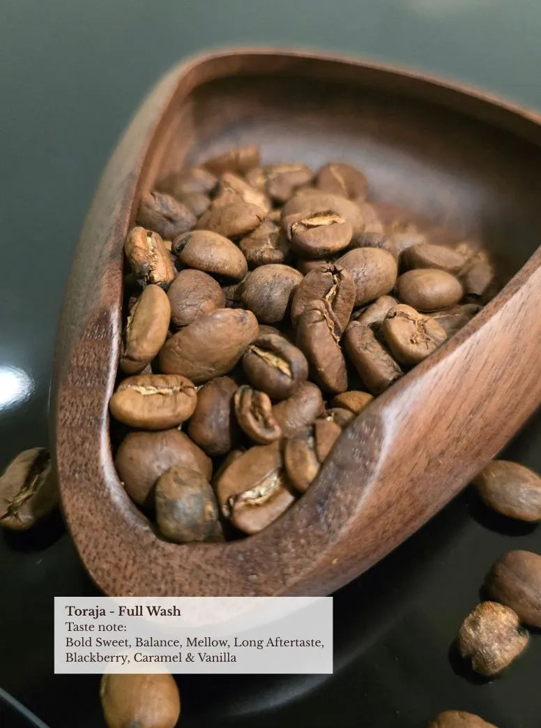 Toraja full wash coffee beans in wooden scoop — bold sweet, mellow, long aftertaste, blackberry, caramel, vanilla
